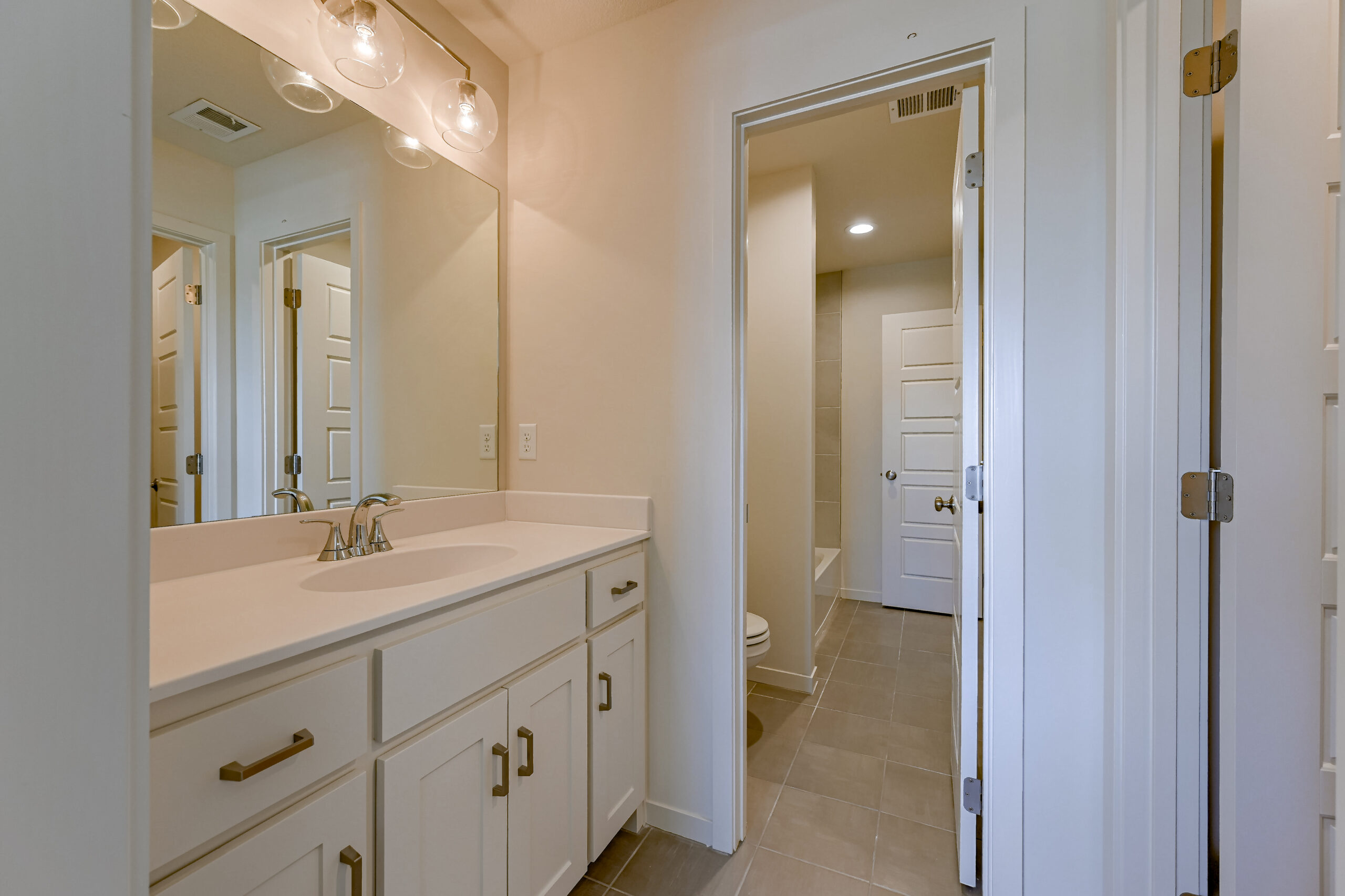 Irving - Secondary Bath showing white painted cabinets